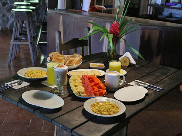 Scrambled eggs, fresh fruit, pancakes, toast, hot coffee breakfast available at Cascada Verde, family hostel by the waterfall in Uvita, Costa Rica