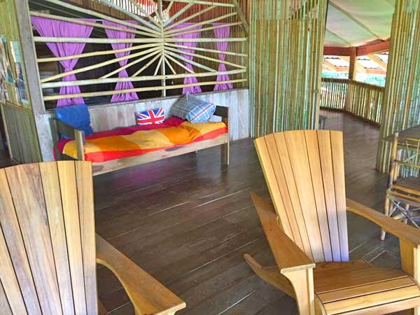 Upstairs terrace. Adirondack chairs. Wood, bamboo, rustic setting.