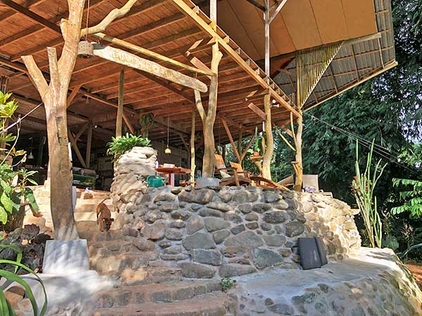 Stone bench to enjoy the jungle view at Cascada Verde hostel in Uvita, Costa Rica